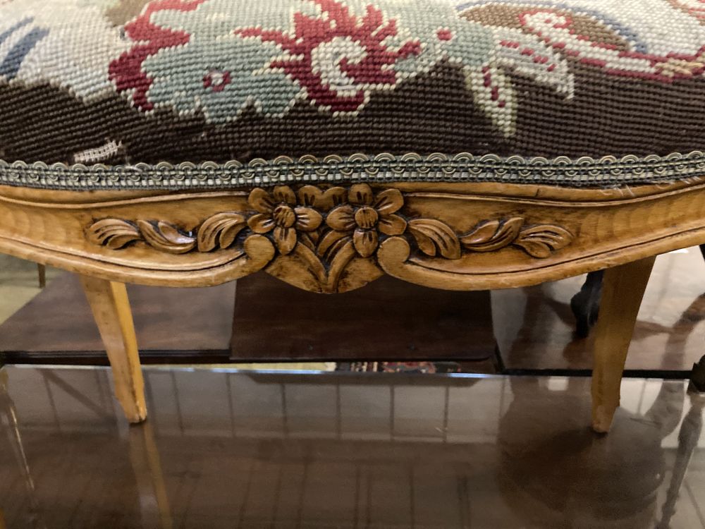 A Louis XVI style walnut dressing stool with tapestry seat, width 76cm, depth 46cm, height 50cm